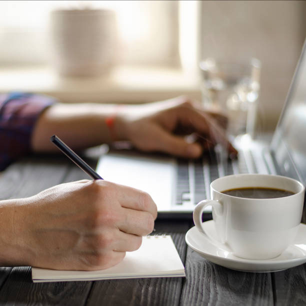 istock Home office workplace. Man analyzes and checking the graph on laptop 1199680149