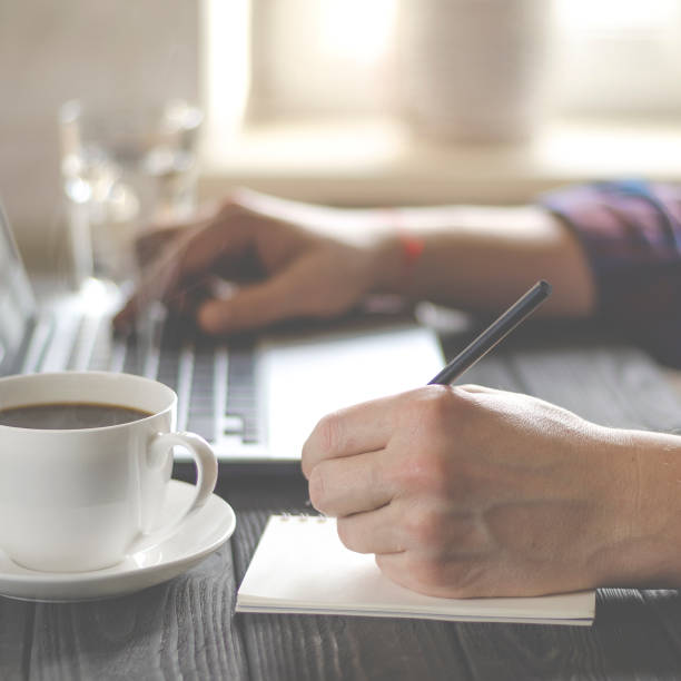 istock Home office workplace. Man analyzes and checking the graph on laptop 1199680848