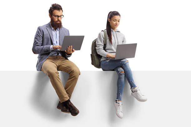 Male teacher and a female student with laptop computers sitting on a panel