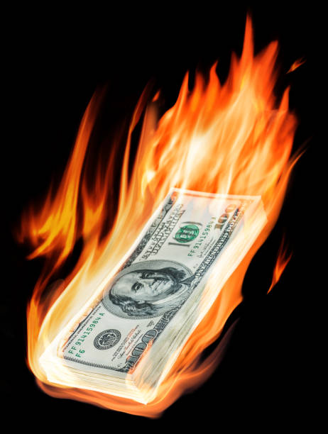 istock Burning one-hundred dollar bills in flames on black background. 1199681454