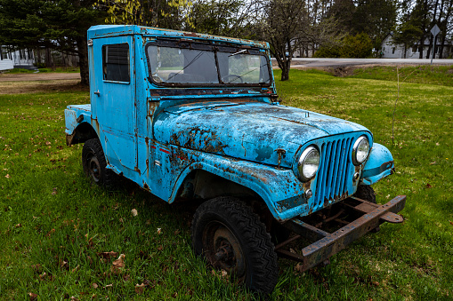 Halifax, Nova Scotia, Canada - May 24, 2019: An old and rusty car and pickup on a Meadow