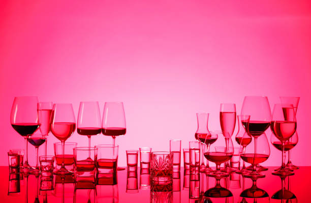 Set of various alcoholic beverages in glasses on a red background. In the presence of liquor, whiskey, vodka, rum, brandy, tequila, gin, red and white wine .