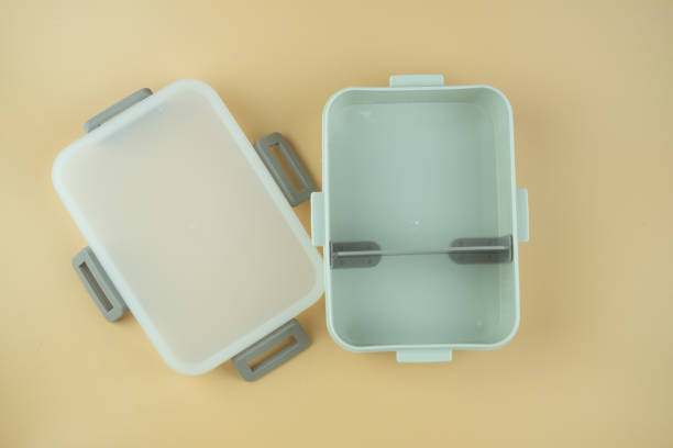 Open plastic lunch box with lid on yellow background. Concept of reduce use plastic Open plastic lunch box with lid on yellow background. Concept of reduce use plastic empty bento box stock pictures, royalty-free photos & images