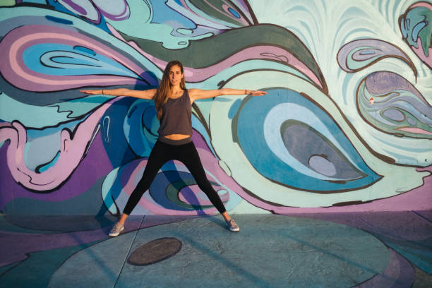 istock Yoga Warrior Three pose against  colorful wall 1199683701