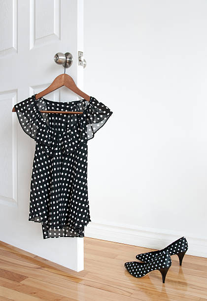 Polka dot shoes and blouse on a hanger