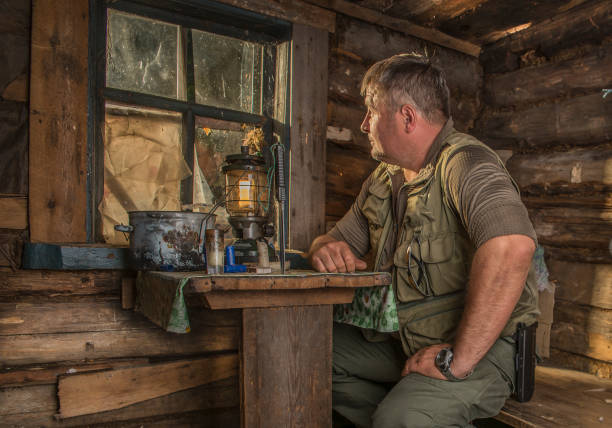 istock A man in a hunting Lodge at the table. 1199684535
