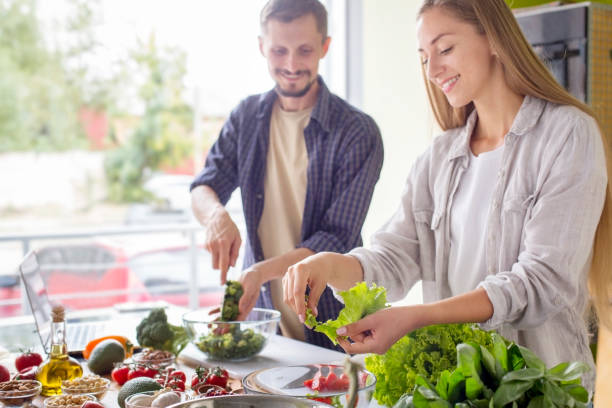 istock Handsome man and attractive young woman cooking together 1199684776