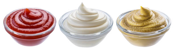 istock Mayonnaise, mustard and tomato sauces in white bowls. Clipping path. 1199684996