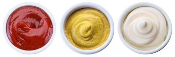istock Mayonnaise, mustard and tomato sauces in white bowls. Clipping path. 1199685171