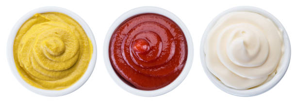 istock Mayonnaise, mustard and tomato sauces in white bowls. Clipping path. 1199687345