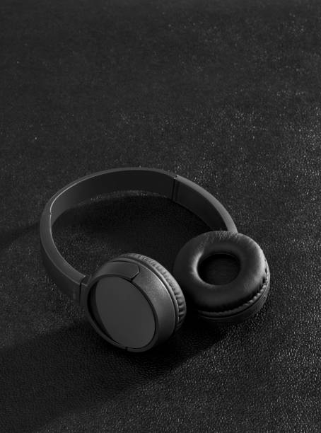 istock Black wireless headphones on desk 1199687525