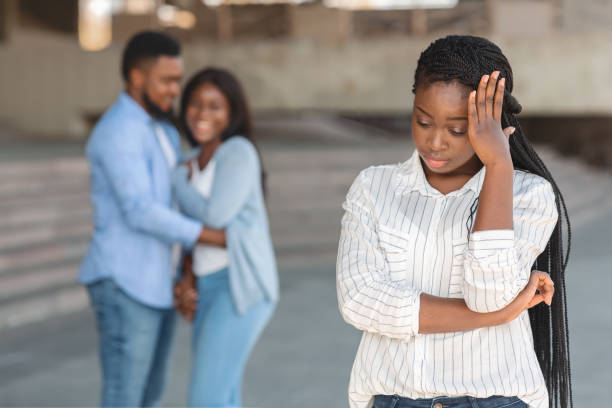 Heartbroken girl depressed to see her ex-boyfriend with another woman Heartbroken black girl depressed to see her ex-boyfriend with another woman, she still in love with him, selective focus jealous ex girlfriend stock pictures, royalty-free photos & images