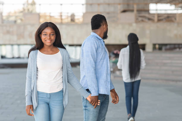 istock Man turning staring at another woman while walking with his girlfriend 1199688734