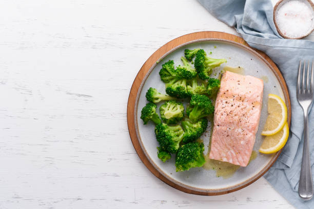 Steam salmon, broccoli, paleo, keto, lshf or dash diet. Mediterranean food. Clean eating, balanced stock photo
