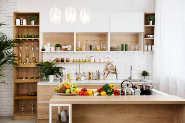 istock Wooden kitchen interior with island and big table 1199689653