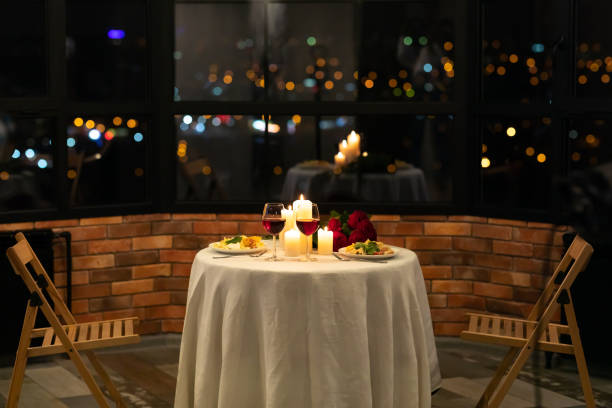 Served Table With Food And Burning Candles In Restaurant Interior Romantic Date Dinner Concept. Served Table With Food And Burning Candles In Restaurant Interior At Night. No People romantic activity stock pictures, royalty-free photos & images