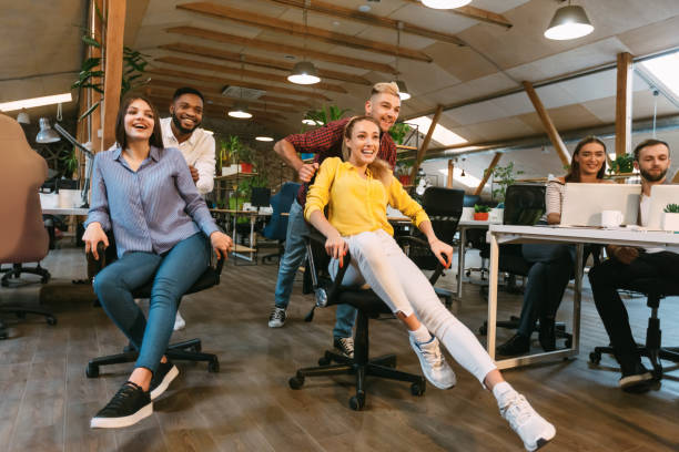 istock Unstoppable team Positive colleagues riding in office chairs 1199689887