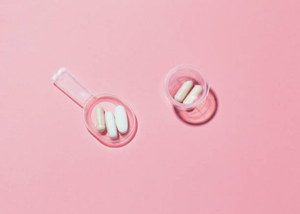 istock Two kinds of serving tablets in plastic cup and measuring spoon. 1199692457