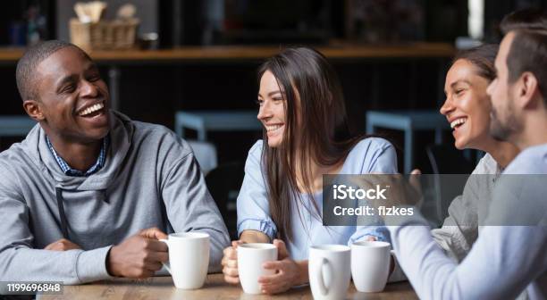 Multiracial Friends Girls And Guys Having Fun Laughing Drinking Coffee Stock Photo - Download Image Now