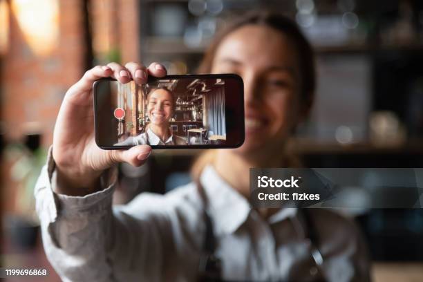 Happy Young Waitress Vlogger Holding Smartphone Recording Video Blog Stock Photo - Download Image Now