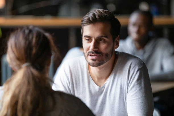 istock Young serious man having conversation with woman girlfriend in cafe 1199696875