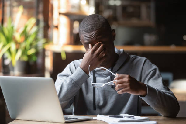 istock Tired stressed black guy take off glasses feel eye strain 1199697099