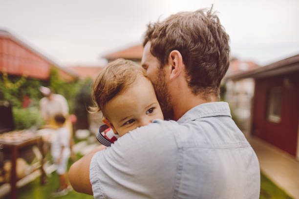 Photo of father and son in their yard