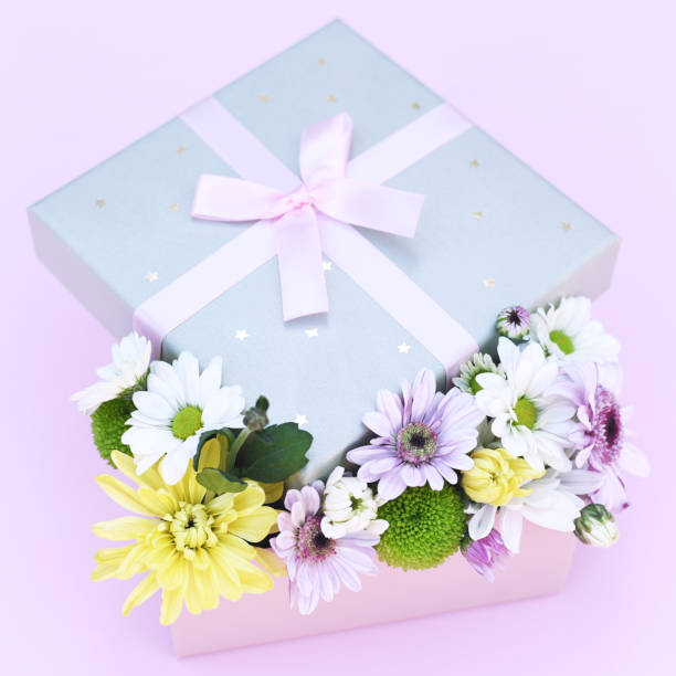 istock Beautiful flower arrangement in a box on a pink background. 1199700140