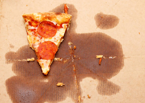 istock One piece of pizza in a cardboard box 1199703684