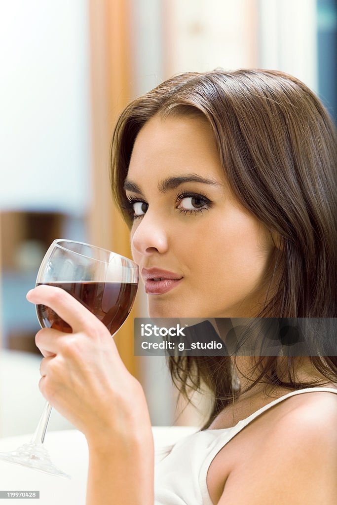 Portrait of young woman with redwine, at home Portrait of young woman with glass of redwine, at home 20-29 Years Stock Photo