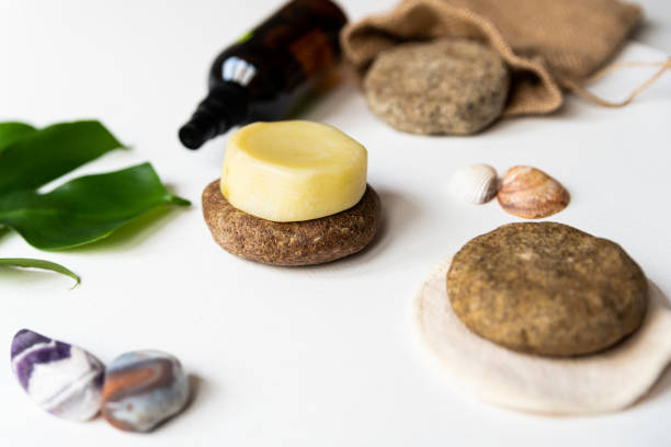 istock yellow and brown solid shampoo discs close up with green natural leaf, example of natural and ecological plastic free cosmetic, homemade with herbs 1199704570