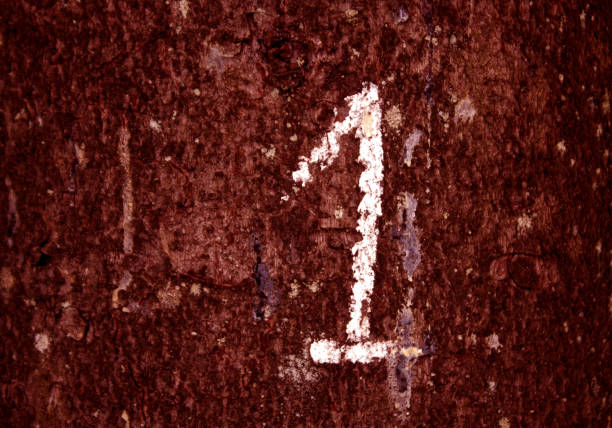 istock Hand written number one on red color grungy wall. 1199704708