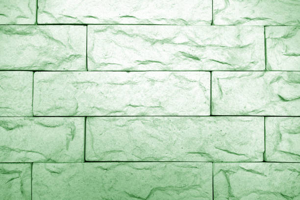 Decorative brick wall in green tone. Abstract background and texture for design.