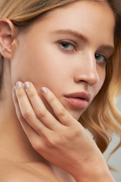istock Gorgeous caucasian blond woman with makeup posing in studio and looking at camera. 1199705111