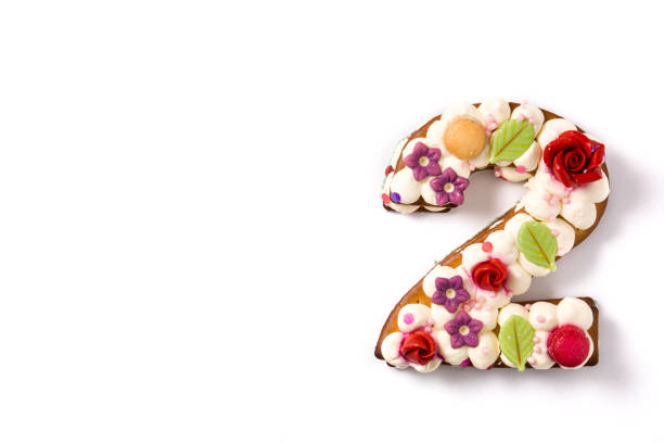 istock Number two cake decorated with flowers, macarons and confetti 1199705925