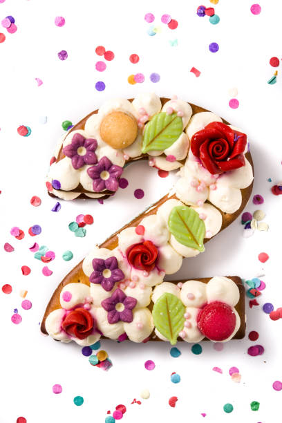 istock Number two cake decorated with flowers, macarons and confetti 1199706053