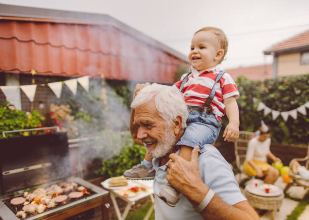 istock With grandfather at the barbecue party 1199706401