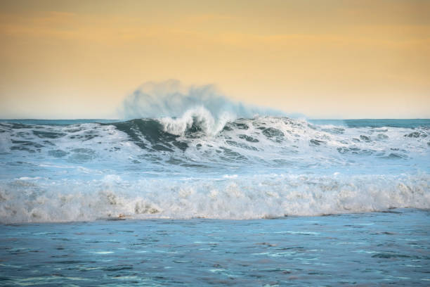 istock Breaking waves into the sea at sunset 1199707966