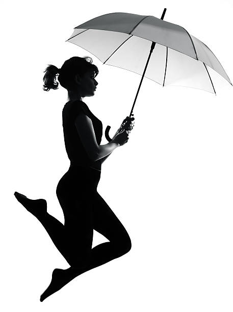 silhouette woman flying holding open umbrella