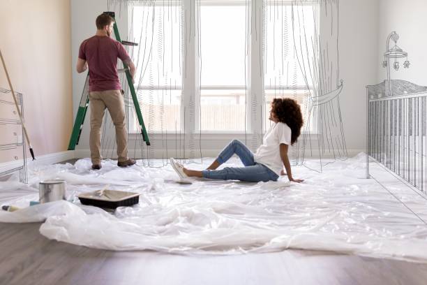 Expectant parents work on baby nursery