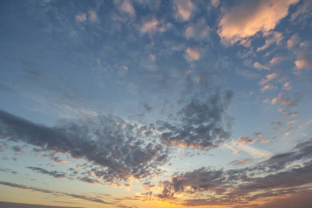 istock Sunset sky covered with orange puffy clouds in the evening. 1199709363