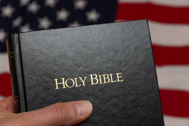 istock hand holding holy bible 1199709617