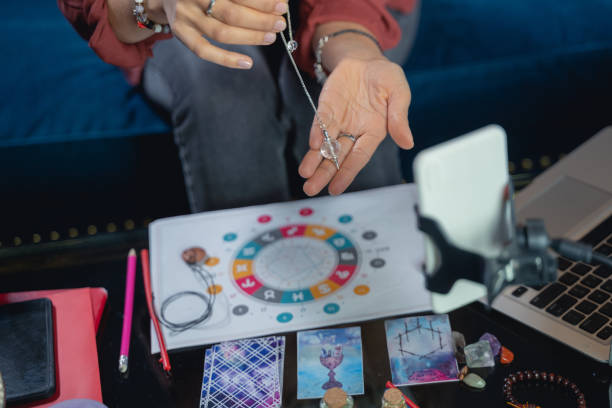 istock Young female astrologer sitting at the table 1199709920