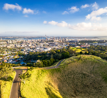 Auckland's sky tower and CBD seen in the distance, with Mount Eden in the foreground.