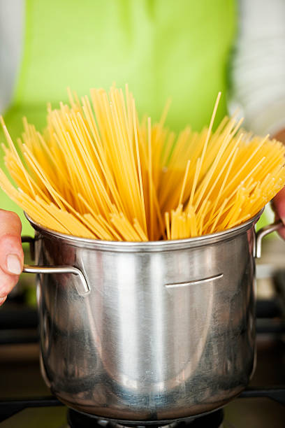 istock Woman Preparing Spaghetti In Pot 119971191