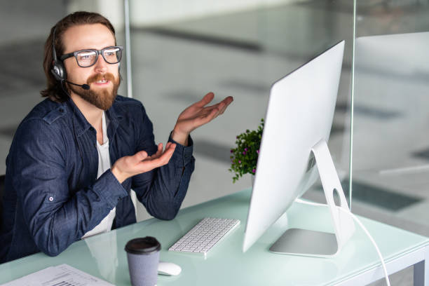 istock Young man call center agent speaking with costumer 1199714486