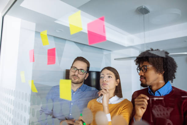 istock Business people brainstorming ideas behind glass wall 1199716873