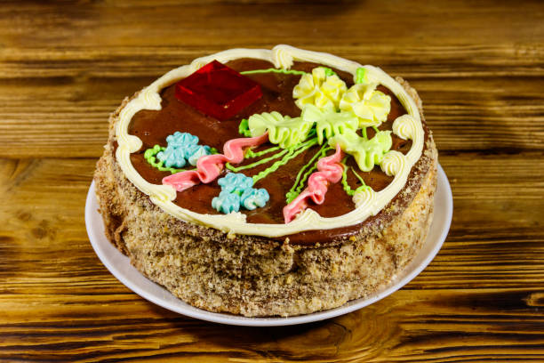 istock Kiev cake with cream, nuts and meringue on wooden table 1199717544
