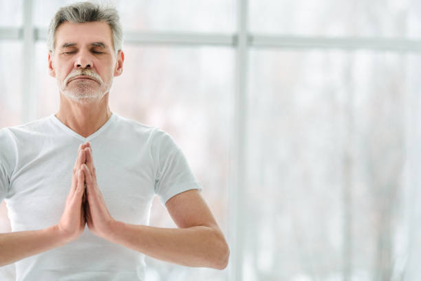 istock Handsome senior man standing in yoga position. Relaxation concept. 1199717767
