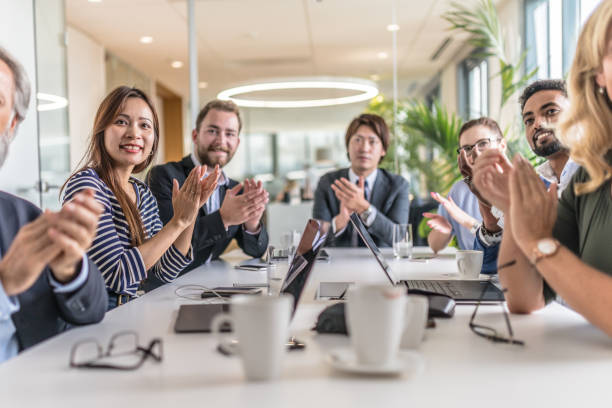 istock Business people at a conference table clapping 1199718502
